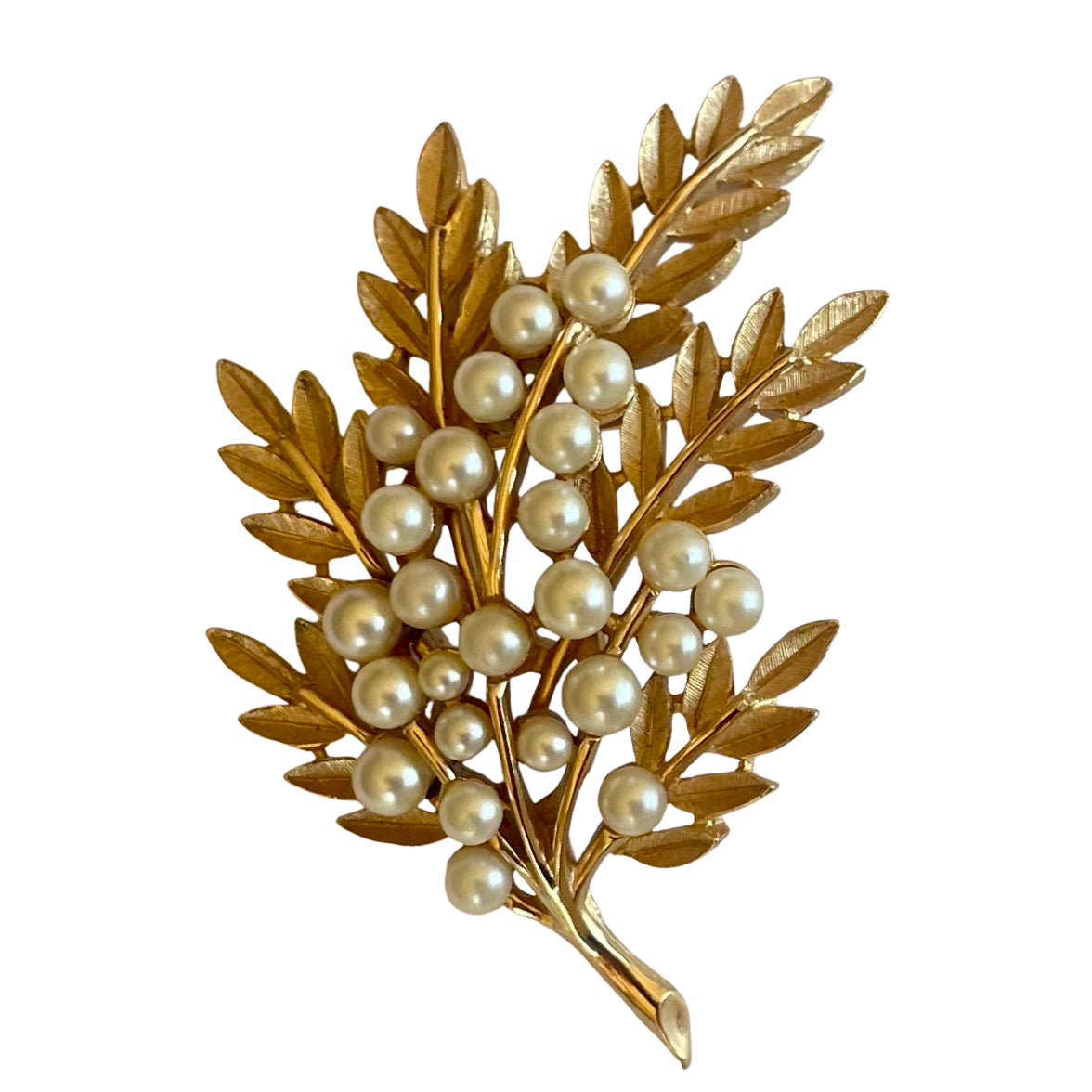 Vintage Crown Trifari 1960s leaf brooch with textured Trifanium leaves, lustrous faux pearls, and polished gold-tone stems, signed to the reverse.