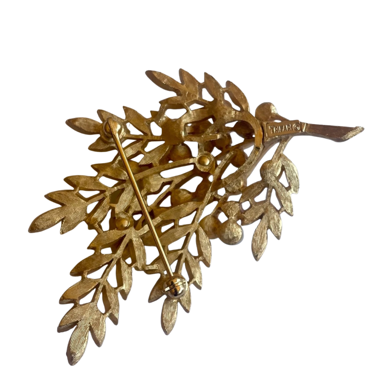 reverse side of Vintage Crown Trifari 1960s leaf brooch with textured Trifanium leaves, lustrous faux pearls, and polished gold-tone stems, signed to the reverse.