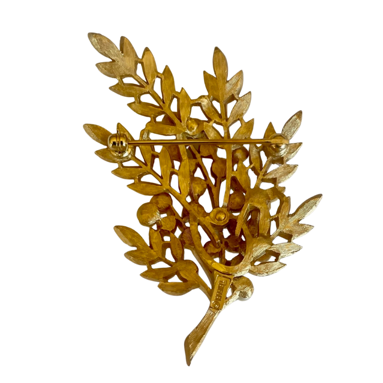 reverse side of Vintage Crown Trifari 1960s leaf brooch with textured Trifanium leaves, lustrous faux pearls, and polished gold-tone stems, signed to the reverse.