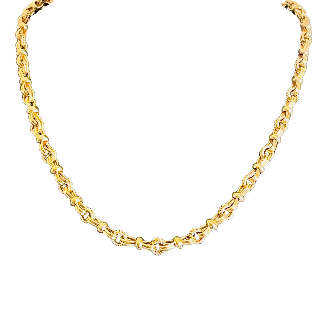 Vintage 1980s Christian Dior gold-plated long statement chain necklace on a white background. Close-up shows alternating smooth bars and twisted faux-rope links.