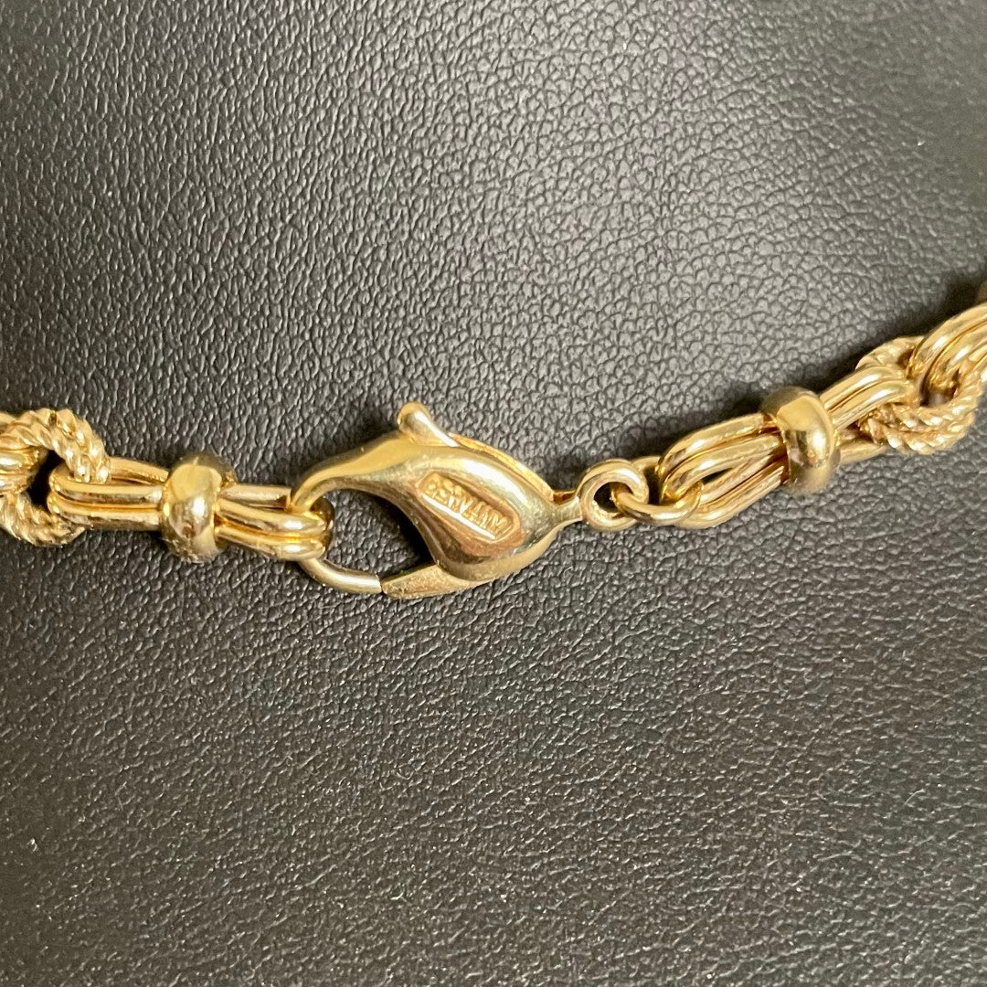 Close up of Chr. Dior  GERMANY logo  Vintage 1980s Christian Dior matinee length chain necklace in 18ct yellow gold plating, featuring an alternating pattern of stylized figure-of-eight links and textured rope-twist segments, displayed on white background