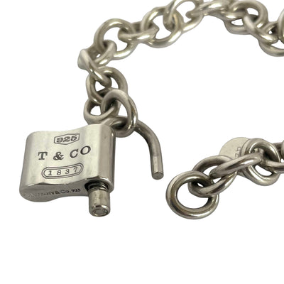 Vintage Tiffany & Co 1837 sterling slver padlock charm bracelet with heavy rolo links  showing padlock opening mechanism on white background