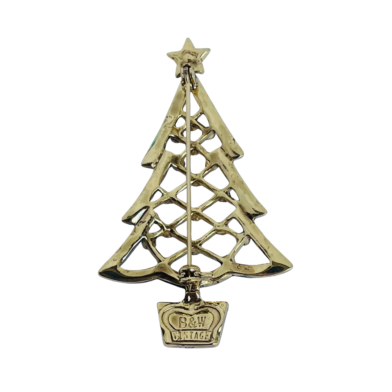 A vintage gold Christmas tree brooch with a star topper, openwork tree design, and a crown-shaped tag at the bottom engraved with 'B&W VINTAGE'.