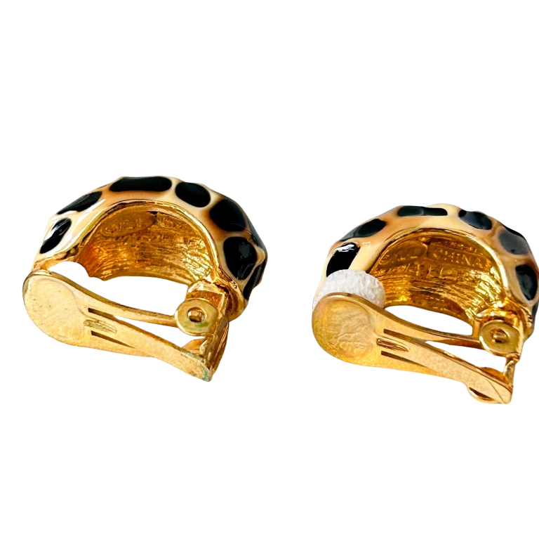 reverse side of vintage Kenneth Jay Lane gold-plated clip-on hoop earrings with a glossy cream and black enamel giraffe print pattern