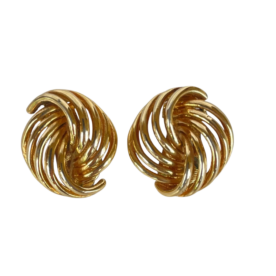 Pair of vintage 1980s gold Dior ribbon swirl clip-on earrings showing the front textured dome design.