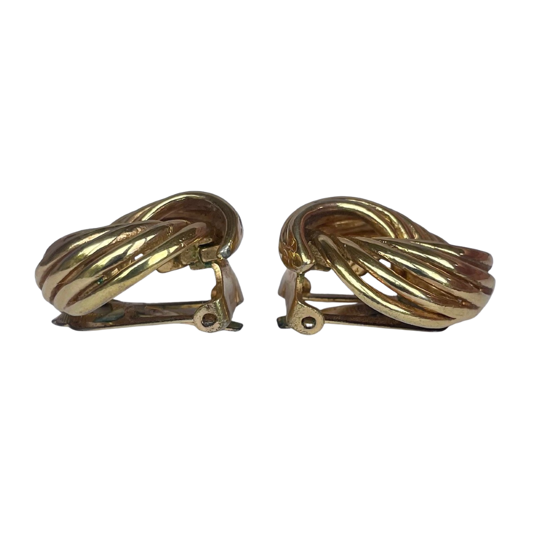 Pair of vintage 1980s gold Dior ribbon swirl clip-on earrings showing the side dome design.
