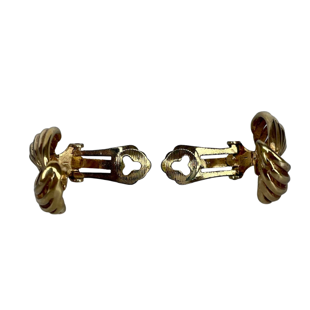 Pair of vintage 1980s gold Dior ribbon swirl clip-on earrings showing the ear clips open