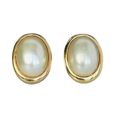 signed Christian Dior Germany vintage costume jewellery, gold plated oval pearl earrings on a plain white backdrop.