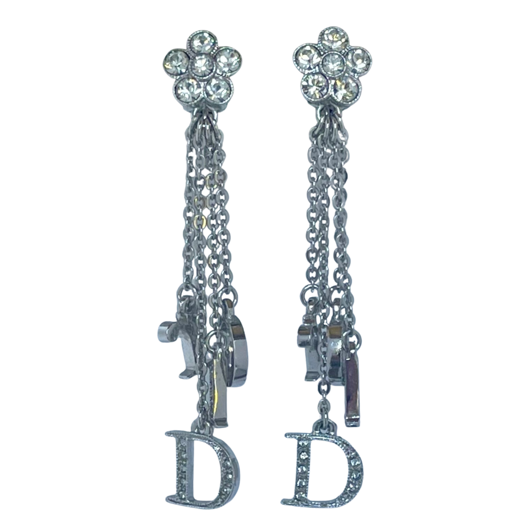 Vintage Christian Dior Y2K clip-on earrings, crystal pavé daisy cluster tops with cascading chains and crystal-set Dior logo letter charms, rhodium-plated, front view