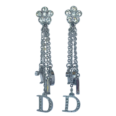 Vintage Christian Dior Y2K clip-on earrings, crystal pavé daisy cluster tops with cascading chains and crystal-set Dior logo letter charms, rhodium-plated, front view