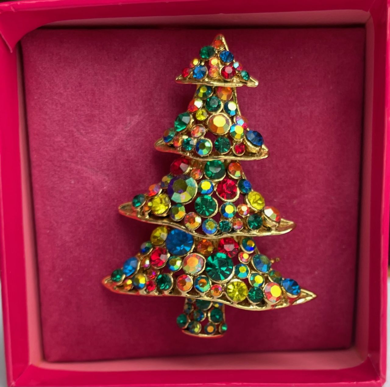 Vintage Butler & Wilson gold-tone Christmas tree brooch with multi-coloured crystals, shown in its original pink branded presentation box.
