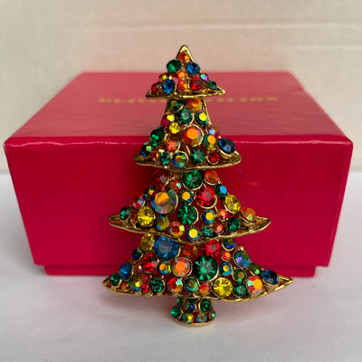 Vintage Butler & Wilson gold-tone Christmas tree brooch with multi-coloured crystals, set against its original pink branded presentation box.