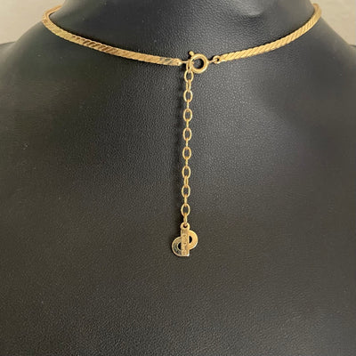 reverse of gold-plated Art Deco style Christian Dior geometric triangle necklace with cream enamel and clear crystal accents showing the lobster clasp and extender chain with Christian Dior signature.