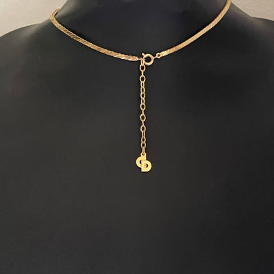 reverse of gold-plated Art Deco style Christian Dior geometric triangle necklace with cream enamel and clear crystal accents showing the lobster clasp and extender chain with CD signature charm.