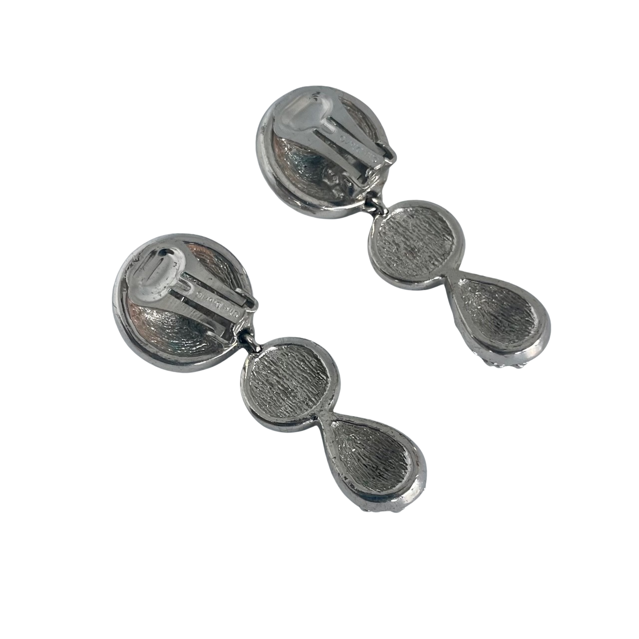 Close-up of a woman wearing vintage 1980s Dior crystal drop earrings with round and teardrop shapes, encrusted with sparkling rhinestones.