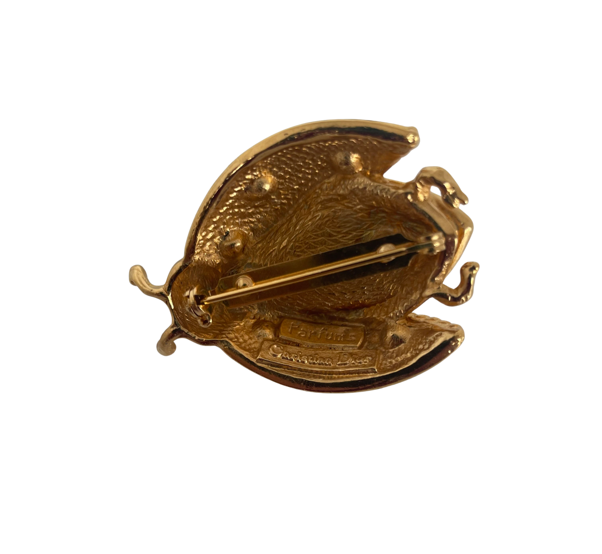 1980s vintage Christian Dior Parfums ladybird brooch with green enamel, gold-plated finish, and sparkling crystals