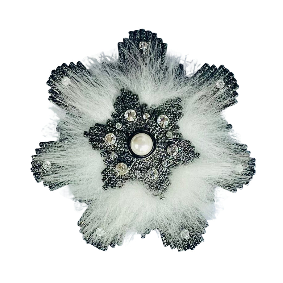 Immaculate vintage Givenchy snowflake brooch from the 1980s. Features a dark japanned metal snowflake outline clear crystals, central faux pearl, and soft white 'fur'.