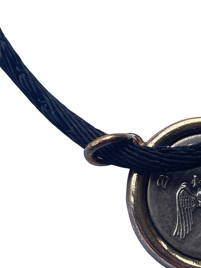 Close-up of the solid 18K yellow gold pendant bail ring showing the official 750 gold purity hallmark stamp.