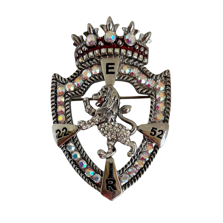 Butler & Wilson Platinum Jubilee brooch featuring E.R. cypher, aurora borealis crystals, ropework border, and rampant lion motif in silver-tone metal.