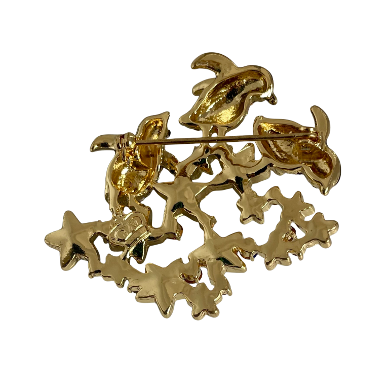 Butler & Wilson brooch with black enamel dolphins leaping over blue crystal stars