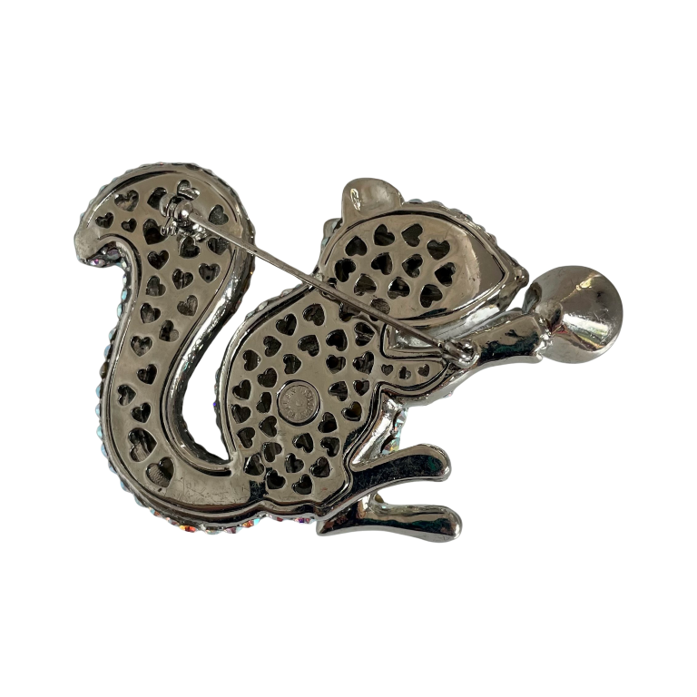 Butler & Wilson squirrel brooch featuring silver-tone metal, aurora borealis crystals, black enamel details, red eye, and crystal nut, presented in box.