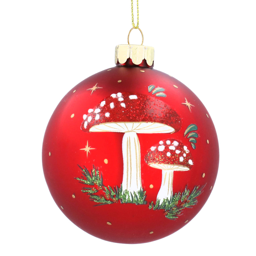 Red Christmas Toadstool tree bauble or ornament with red and white mushrooms and green leaves on a white background 