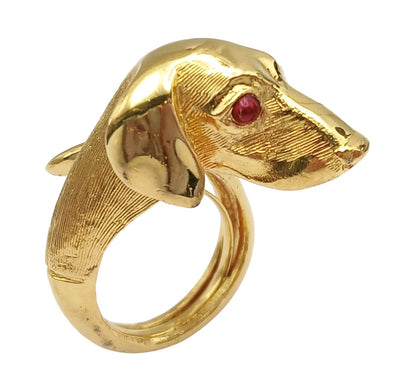 Vintage Crown Trifari Dachshund dog head ring in textured gold-tone Trifarium. This rare bypass style ring features a detailed dachshund face with vibrant red glass cabochon eyes and a wraparound textured band