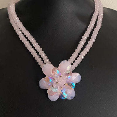 Vintage Butler & Wilson double-strand pink beaded statement necklace with an iridescent crystal flower pendant.