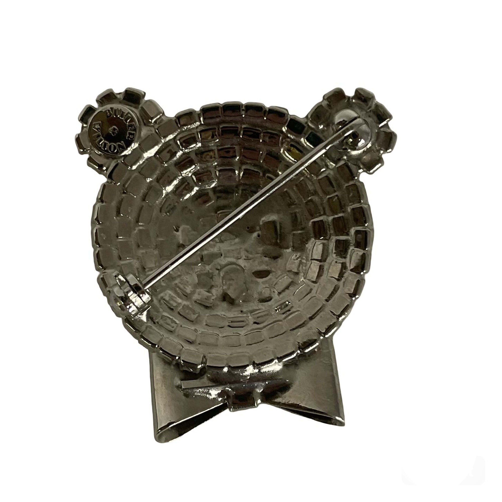 reverse side of vintage Butler & Wilson silver-tone teddy bear head brooch showing secure rollover clasp and Butler & Wilson logo in circular cartouche.