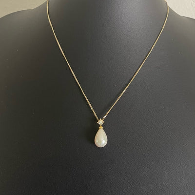 A vintage Christian Dior gold tone necklace with a tear drop faux pearl pendant topped with a sparkling Swarovski crystal.