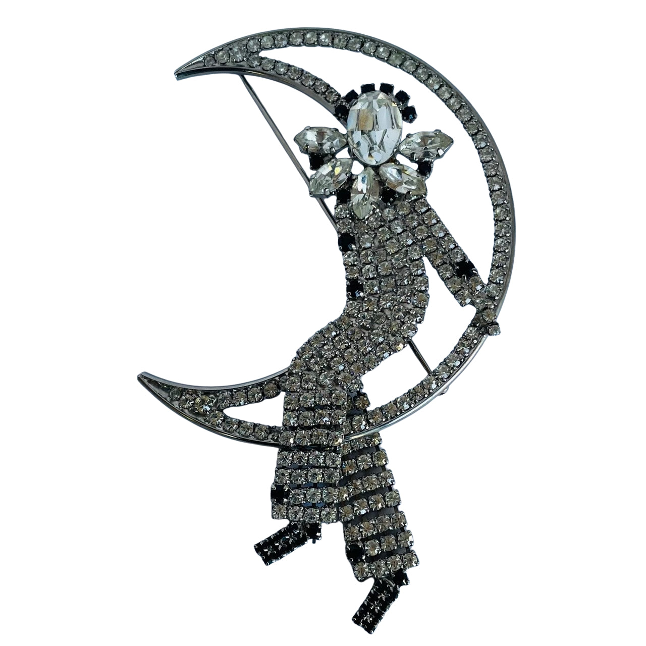 Large vintage 1980s Butler and Wilson crystal Harlequin Pierrot on moon brooch on white background.