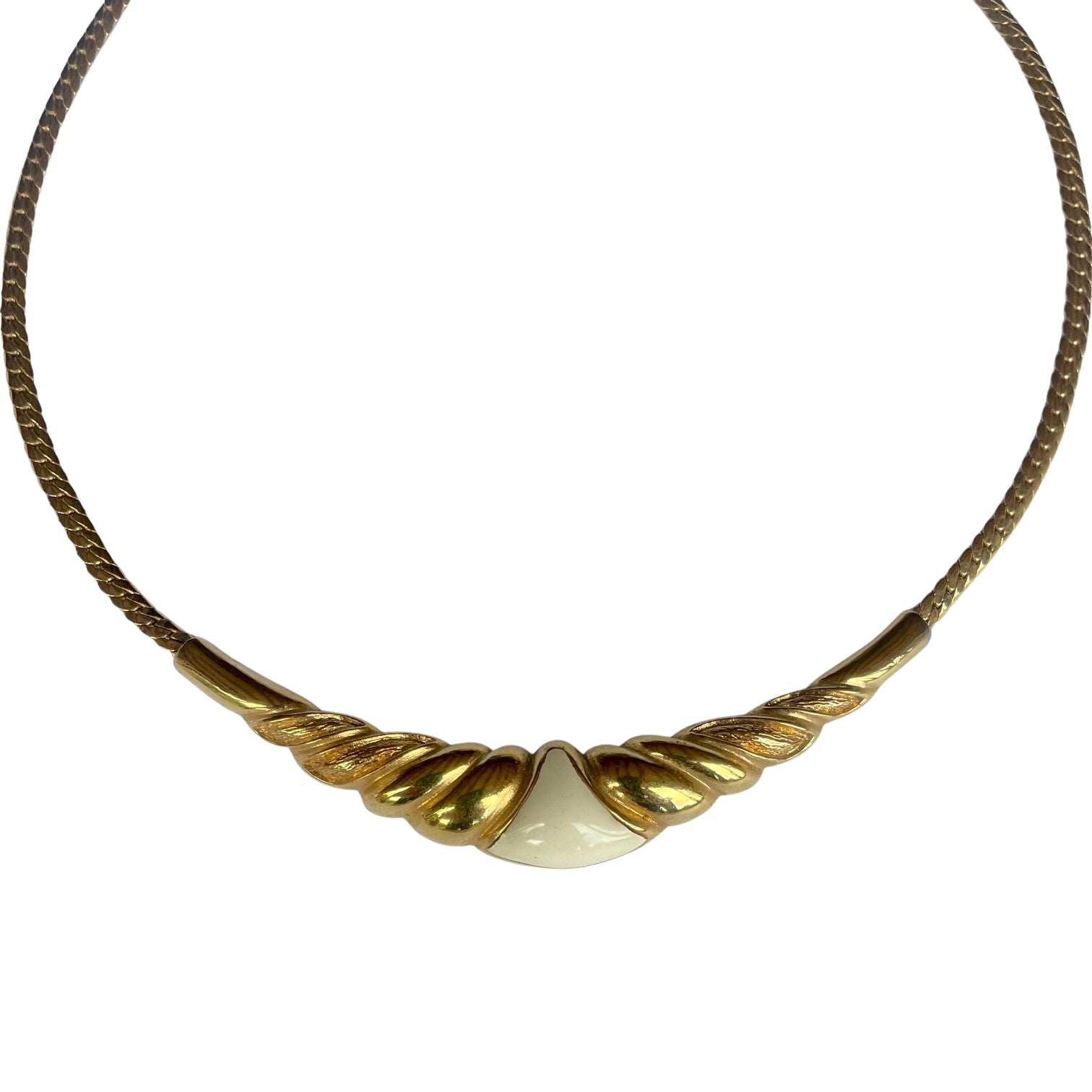 Vintage 1980s Christian Dior gold-plated collar necklace featuring a fluted centerpiece, cream enamel shield insert, and signed CD charm. Excellent condition