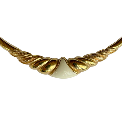 Vintage 1980s Christian Dior gold-plated collar necklace featuring a fluted centerpiece, cream enamel shield insert, and signed CD charm. Excellent condition