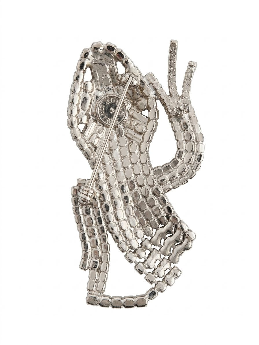 Close up of the reverse of magnificent 19 cm vintage Butler & Wilson silver-tone articulated lizard brooch showing the Butler & Wilson backstamp and top pin fastening.