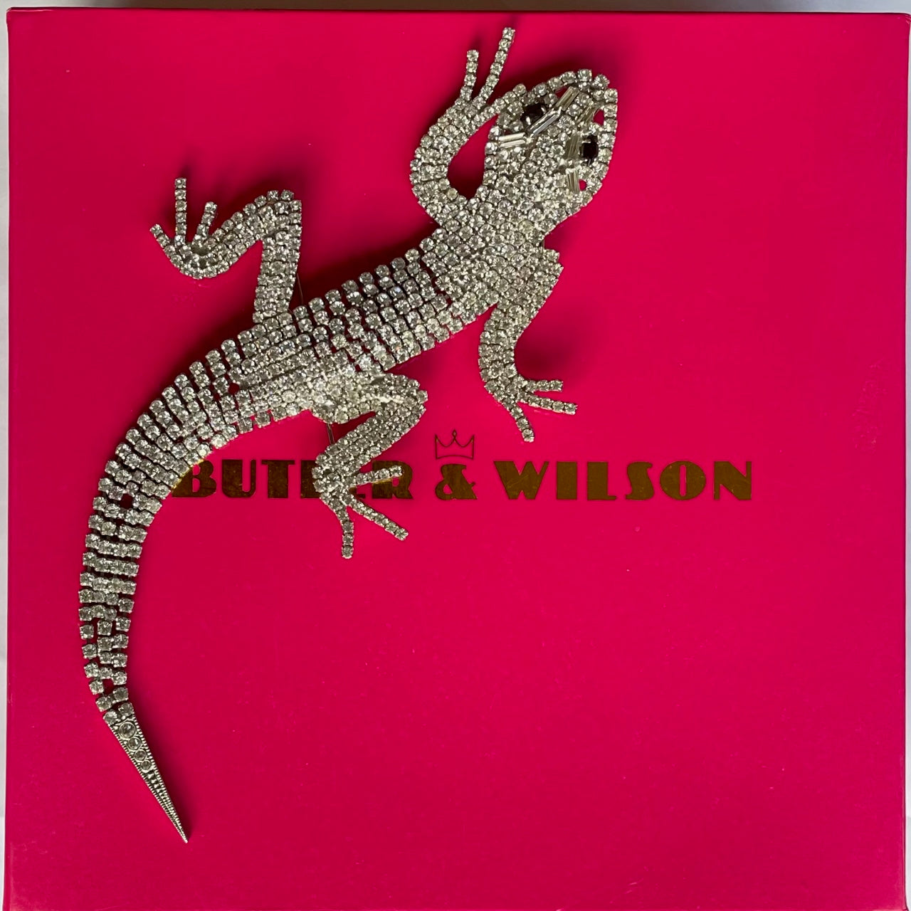 A magnificent 19 cm vintage Butler & Wilson silver-tone articulated lizard brooch encrusted with clear crystals and black eyes, on its Butler & Wilson box.
