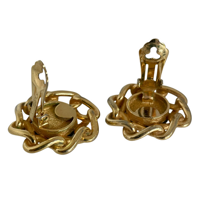 Reverse side of a pair of vintage Christian Dior clip earrings with polished gold-plated chain and black cabochons showing the ear clip mechanism