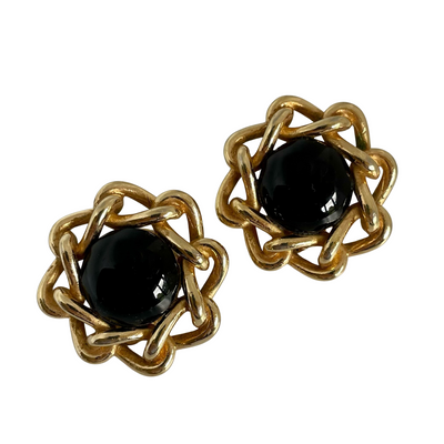 A pair of vintage Christian Dior clip earrings with polished gold-plated chain and black cabochons.