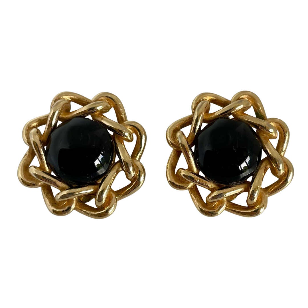 A pair of vintage Christian Dior clip earrings with polished gold-plated chain and black cabochons.