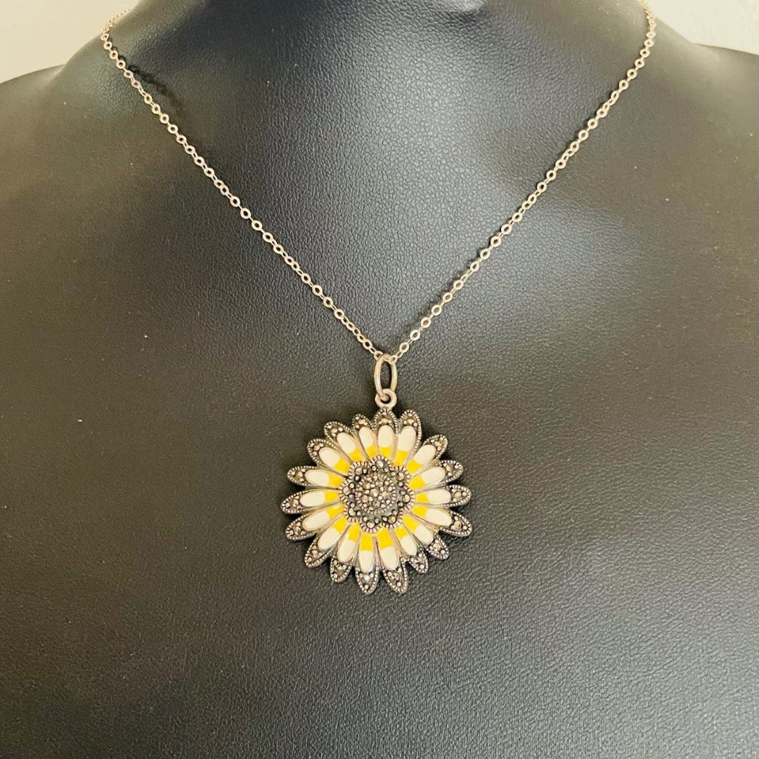 Vintage sterling silver daisy pendant necklace with marcasite border and yellow and cream enamel petals, on a new 18 inch sparkly silver chain.