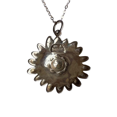 reverse of Vintage sterling silver daisy pendant necklace with marcasite border and yellow and cream enamel petals, on a new 18 inch sparkly silver chain, marked 925 A Thailand.