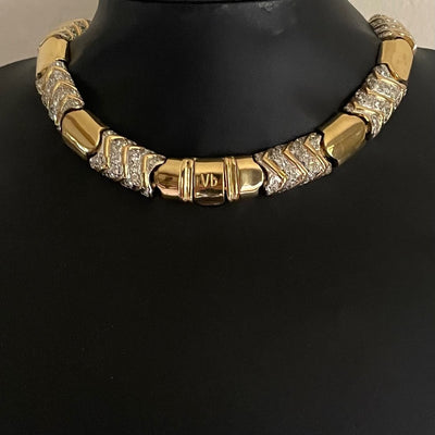 vintage Vogue Bijoux gold-tone collar necklace with pavé crystal chevrons displayed on a black mannequin bust, highlighting the prominent "Vb" stamped clasp at the front centre