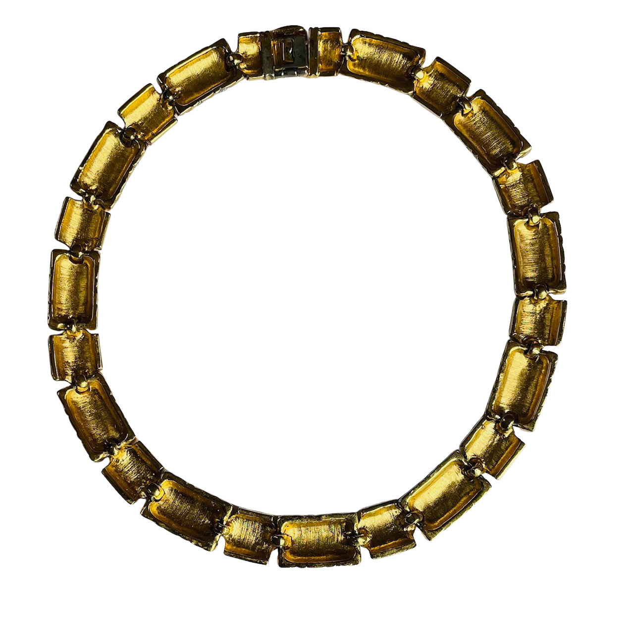 reverse side of the vintage Vogue Bijoux collar necklace, showing a textured, brushed gold-tone finish across the hollowed backs of the rectangular and chevron segments. The individual links are connected by small metal bars, and a box clasp closure sits at the top of the circular arrangement against a white background