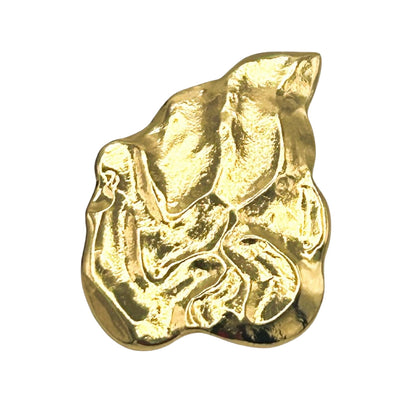Front view of a vintage Yves Saint Laurent gold flame leaf brooch designed by Robert Goossens, showcasing its heavily textured, abstract organic design.