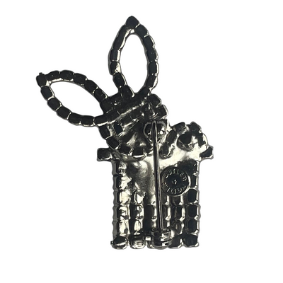 reverse side of Butler & Wilson rabbit in top hot brooch showing pin mechanism and Butler & Wilson mark in circular cartouche.